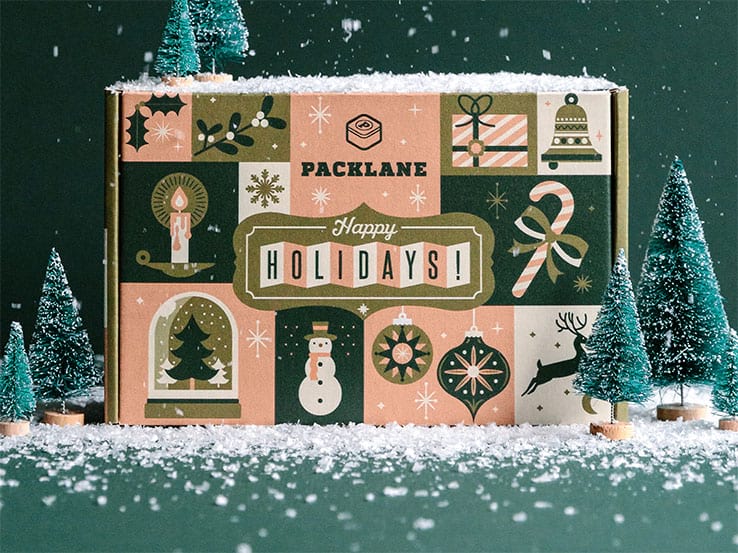 Dark green and brown holiday packaging against a dark green background